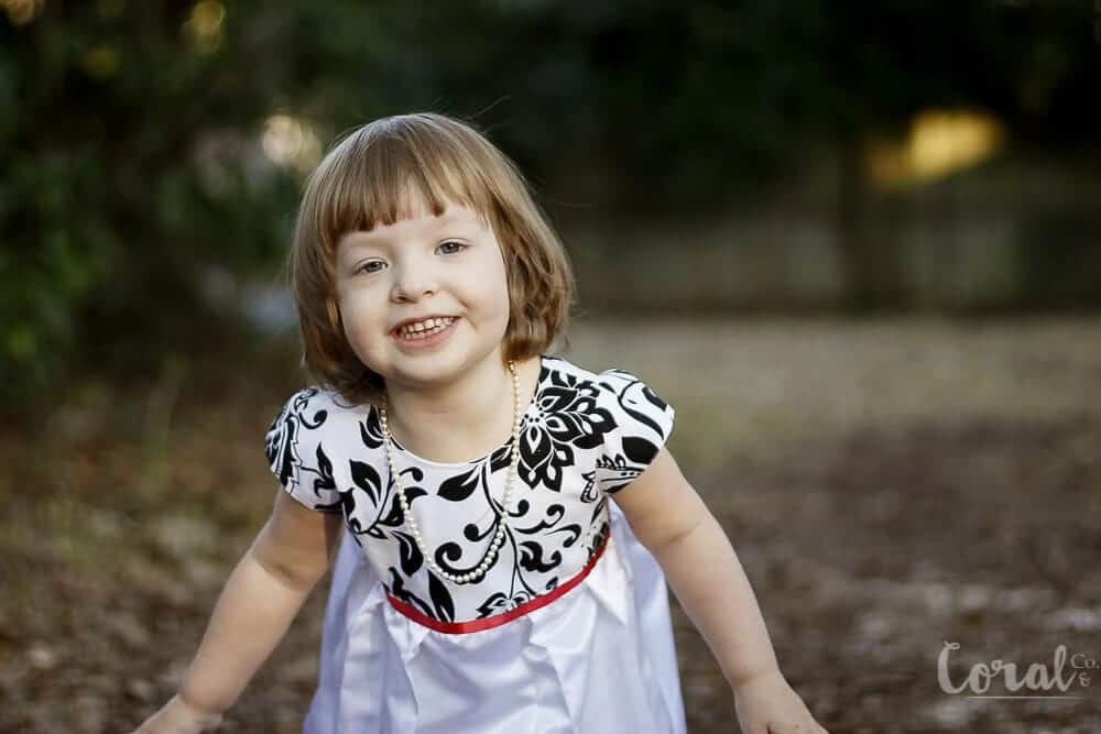 little-girl-smiling-deranium-dress